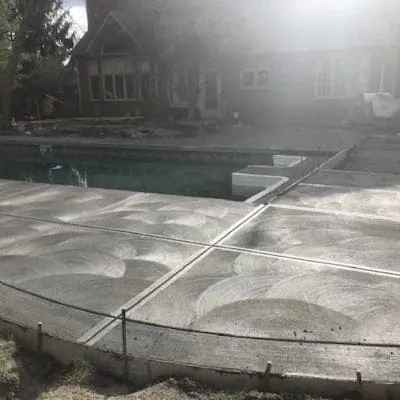 Newly poured broom-finish pool deck with curved joints